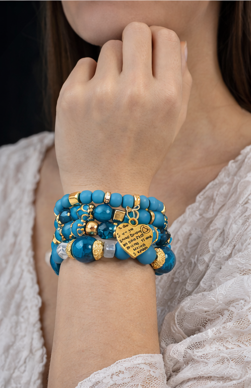 Ensemble de bracelets bleu turquoise et doré porté au poignet