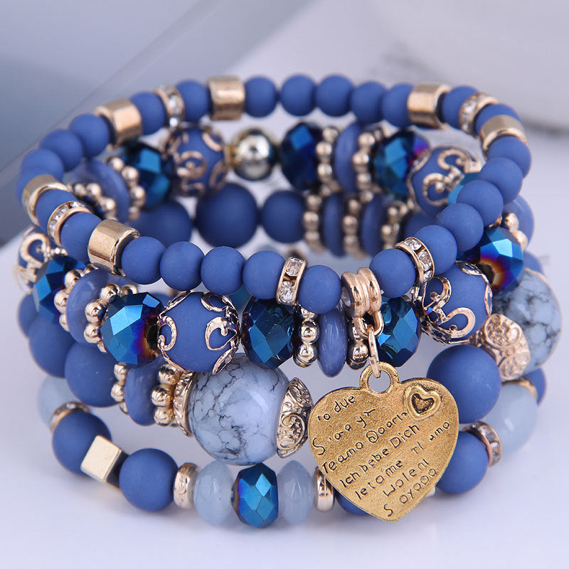 Ensemble de 4 bracelets multirangs bleus avec perles, détails dorés et pendentif cœur