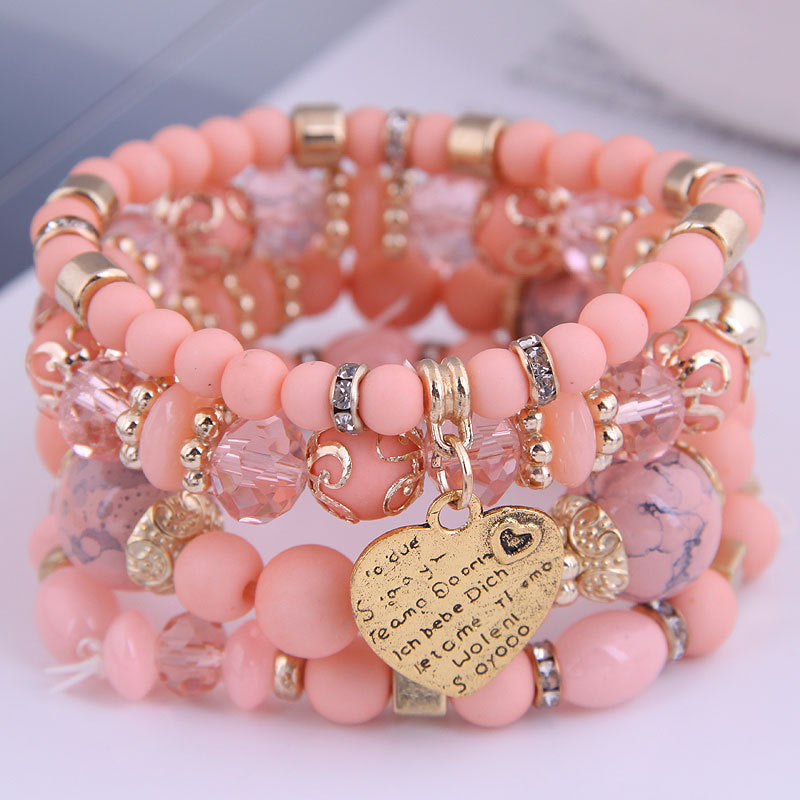 Ensemble de 4 bracelets multirangs roses avec perles, détails dorés et pendentif cœur