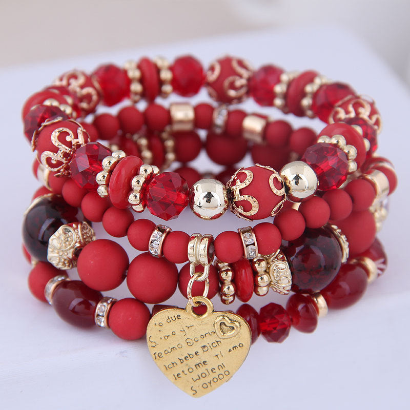 Ensemble de 4 bracelets multirangs rouges avec perles, détails dorés et pendentif cœur