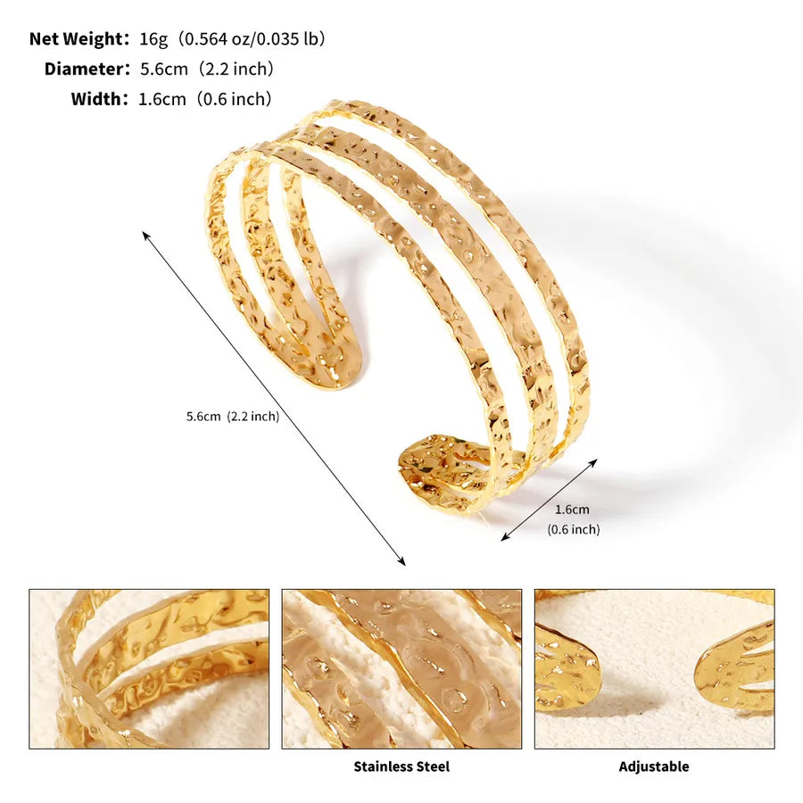 Bracelet manchette doré ouvert à trois rangs texturés ; l’image indique 5,6 cm de diamètre et 1,6 cm de largeur